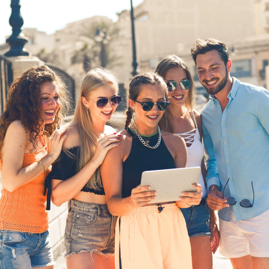 4 girls and one guy looking at an ipad